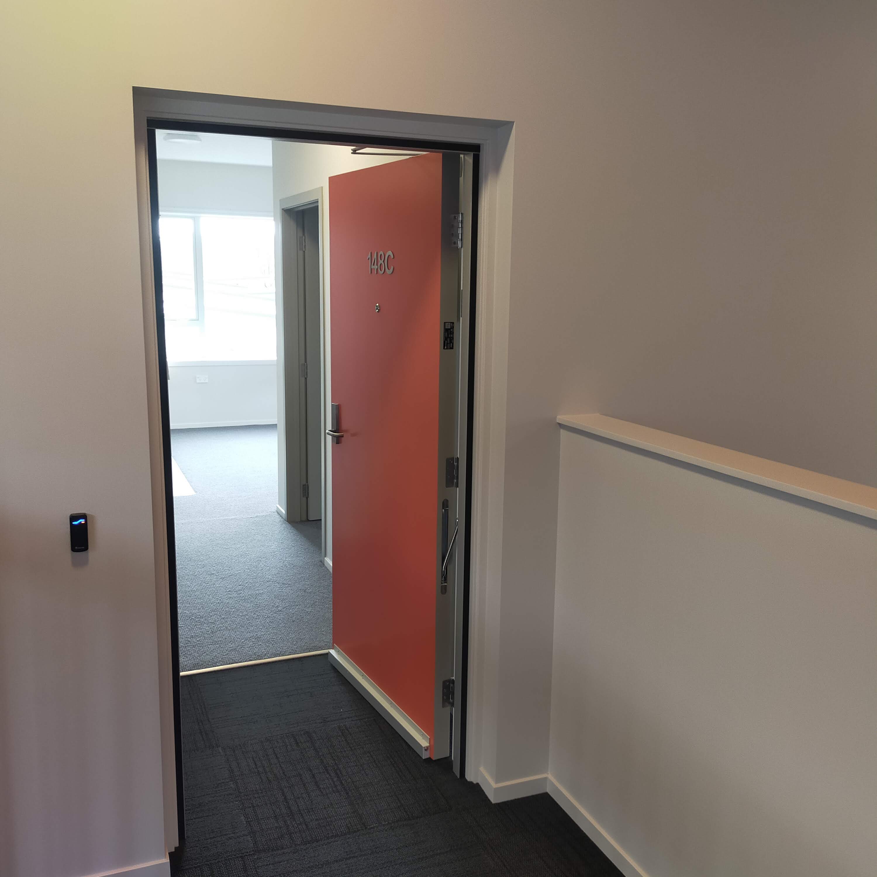 Multi-unit complex - orange accent door with unit numbering
