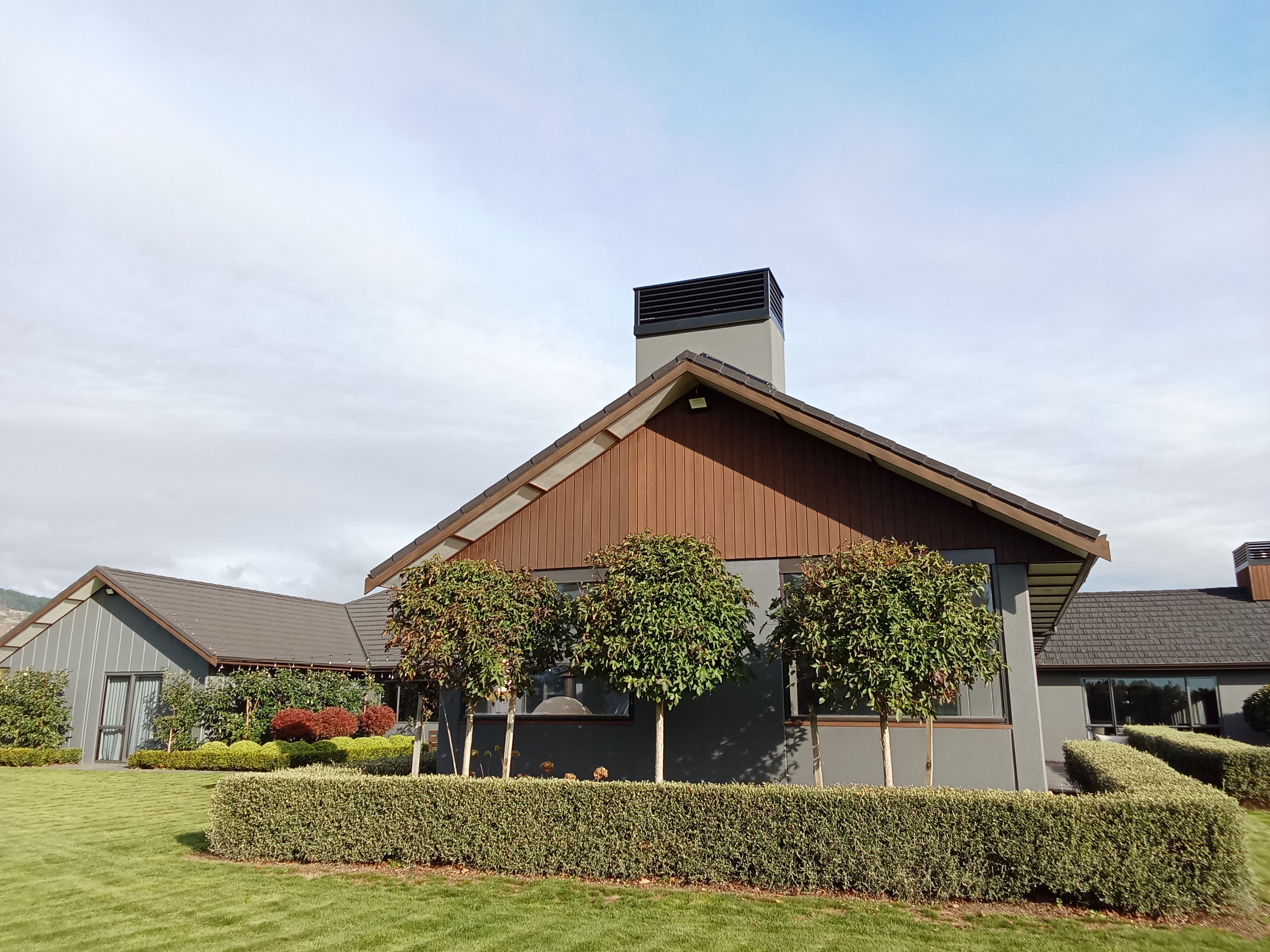 Lifestyle home exterior - cedar gable with grey-green plastered walls