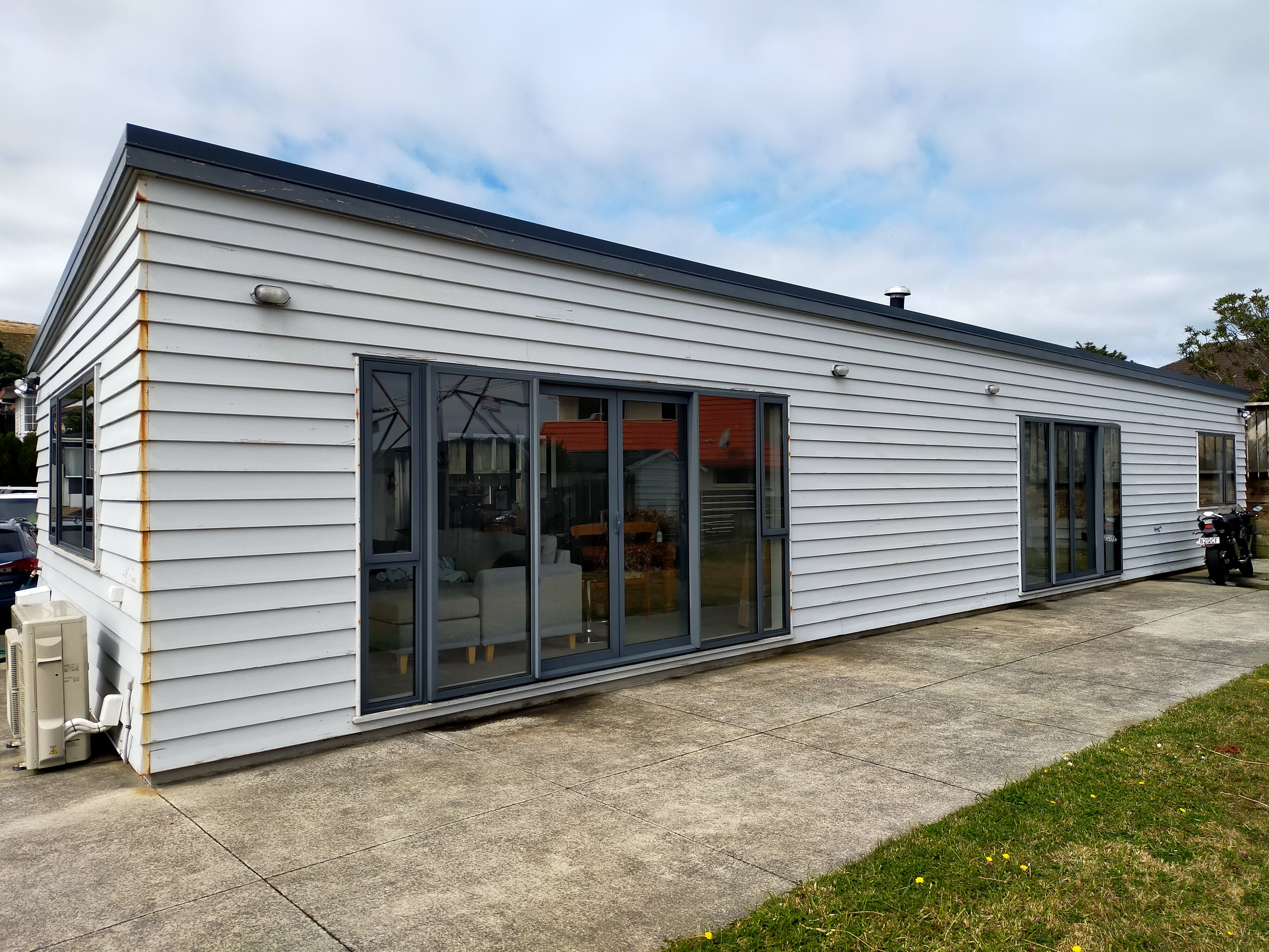 White weatherboard house - fresh paint with dark window trims