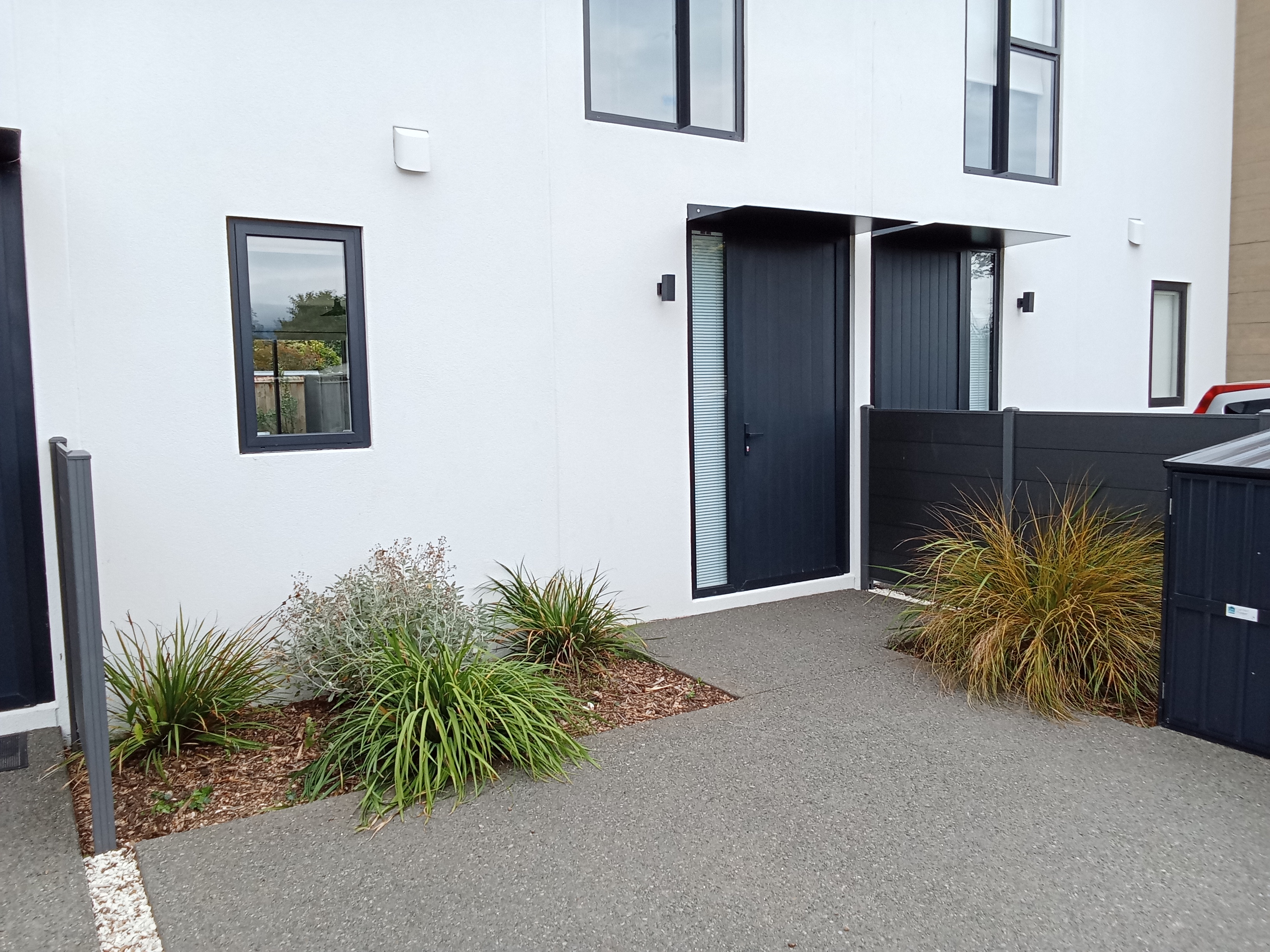 Modern townhouse entry - white exterior with dark accents